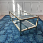 Table basse dorée à plateaux de verre